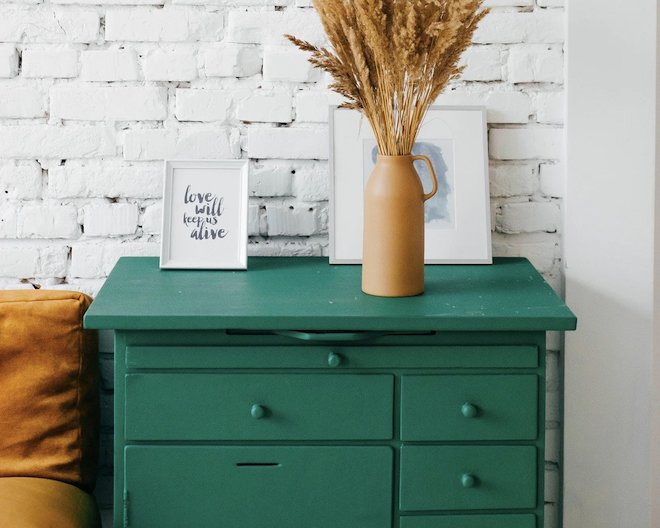 stylish green drawers in the corner of a room